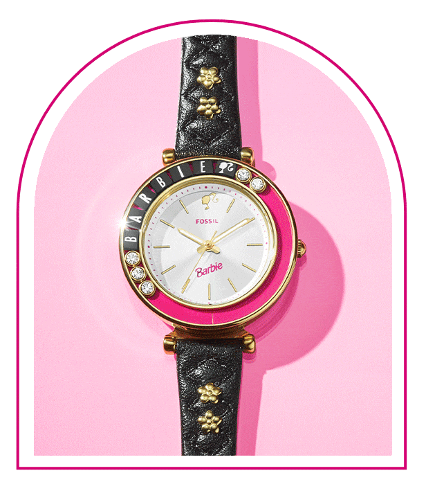 A pink background with a Barbie™ Mansion-inspired window. Inside the window sits our limited-edition Barbie™ x Fossil watch ring, featuring a gold-tone five-petal flower design, white dial with pink barbie logo and flexible band to fit any finger.